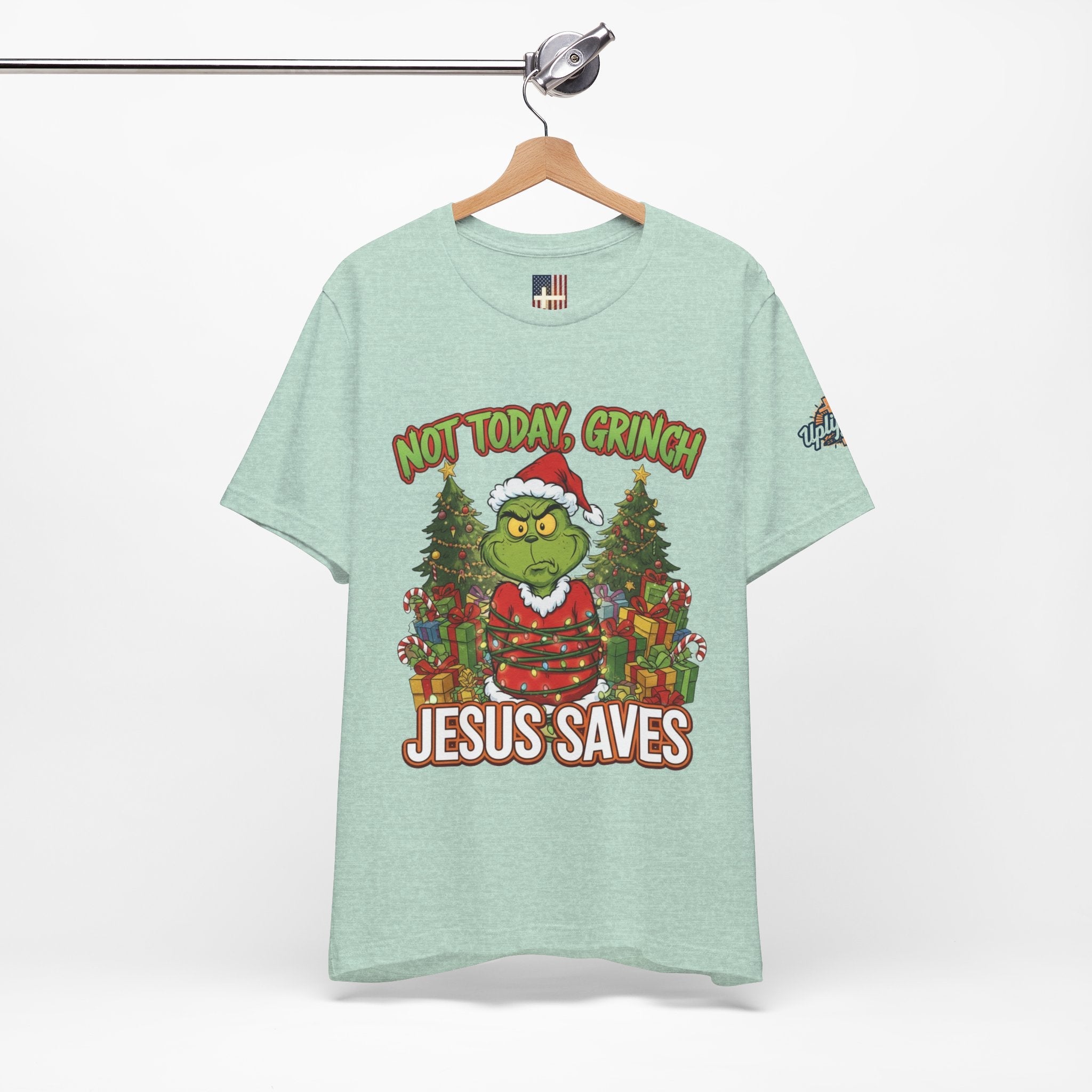 🎄 Not Today, Grinch – Jesus Saves | Funny Christian Christmas T-Shirt | Sulking Grinch & Glowing Cross | Bold Neon Faith Tee by Uplifted Gear Printify